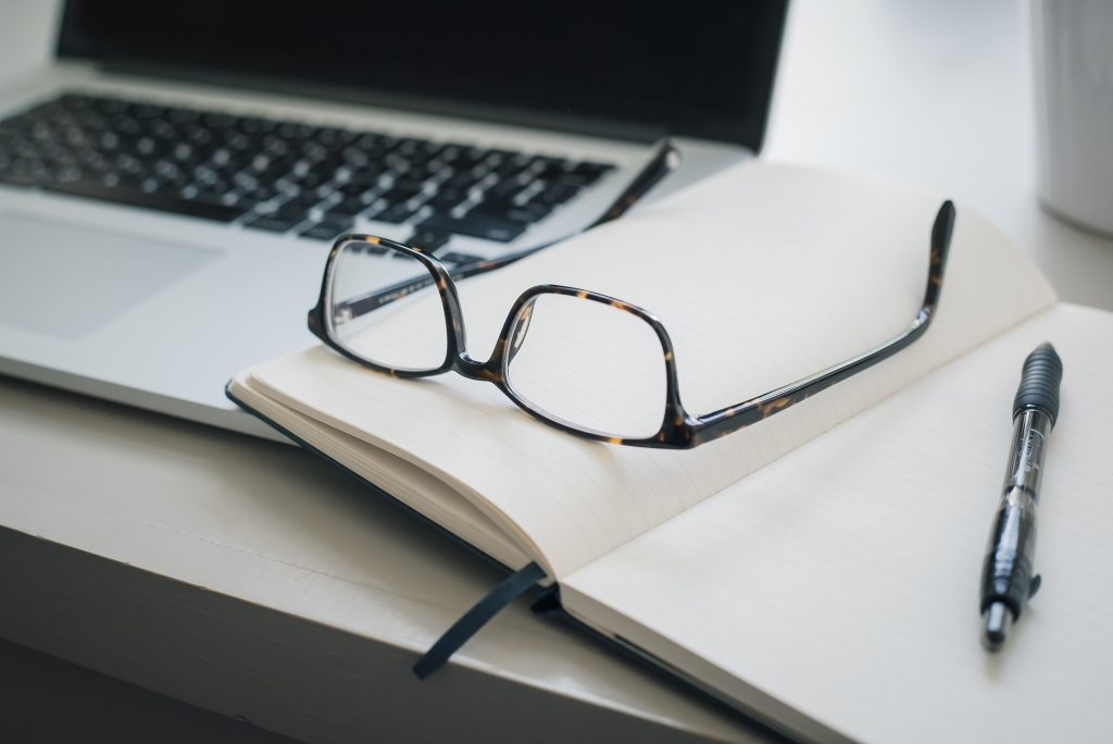 How to resign: picture showing a laptop with glasses and a notebook