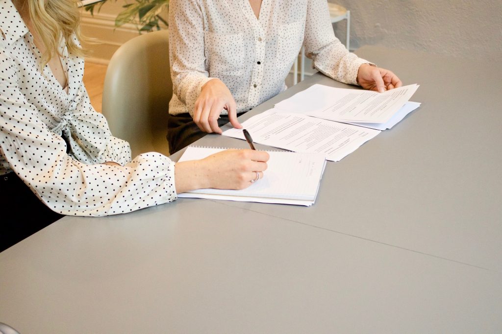 Handling a counteroffer: women looking through a contract