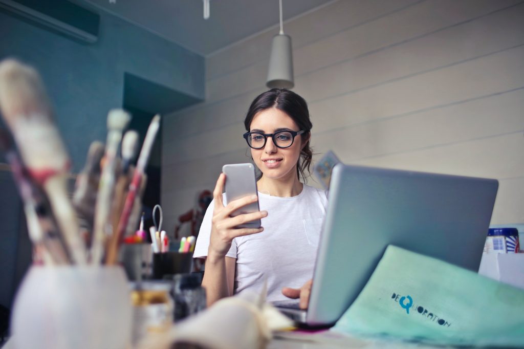 Social media screenings: a woman using her smart phone to look at her social media